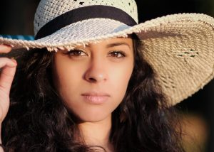 Woman wearing a large sun hat.