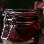 a jar filled with liquid sitting on top of a table