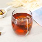 clear glass cup with brown liquid