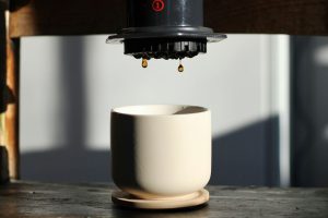 a coffee cup sitting on top of a wooden table