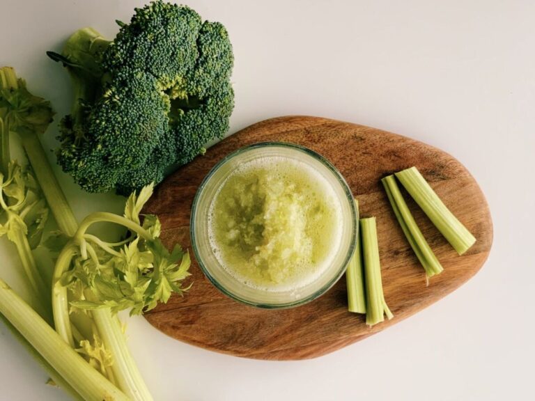 A refreshing green juice made from broccoli and celery, captured in a minimalist flat lay style.