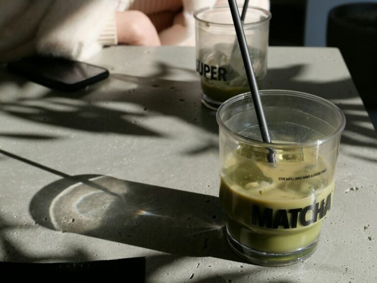 a glass with a straw in it sitting on a table