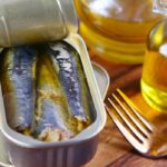 a tin of sardines sitting on top of a wooden table