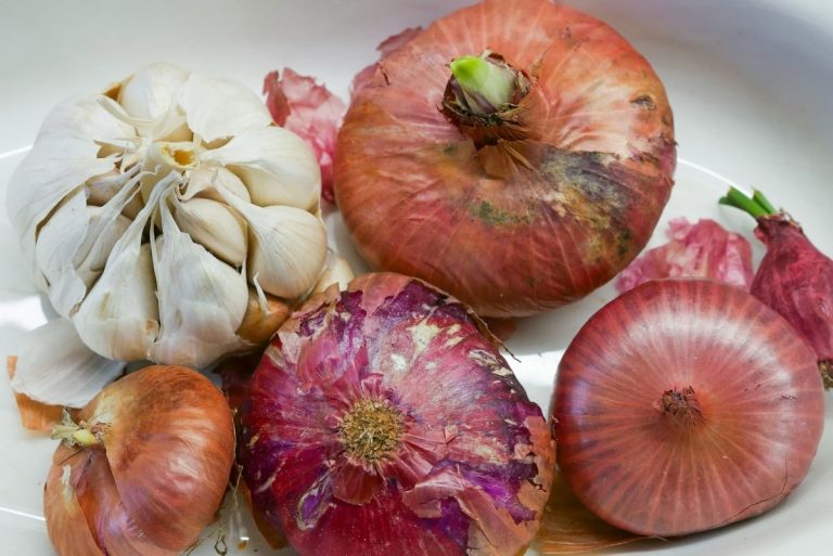 a white plate topped with onions and garlic
