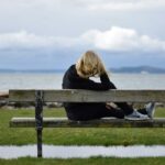 woman in black shirt sitting on bench